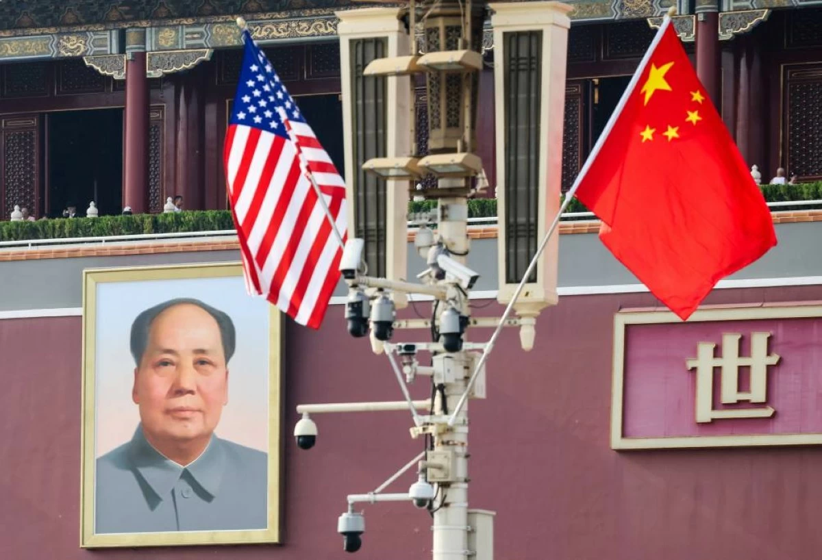 U.S. and China’s national flags flutter next to the portrait of late Chinese Chairman Mao Zedong, ahead of U.S. President Donald Trump's visit to China, in Beijing, China, May 13, 2026. REUTERS/Maxim Shemetov