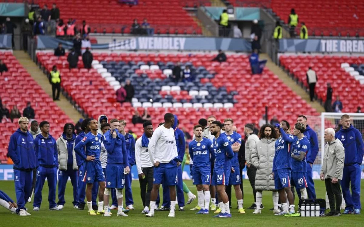 Chelsea players look dejected after the match. REUTERS