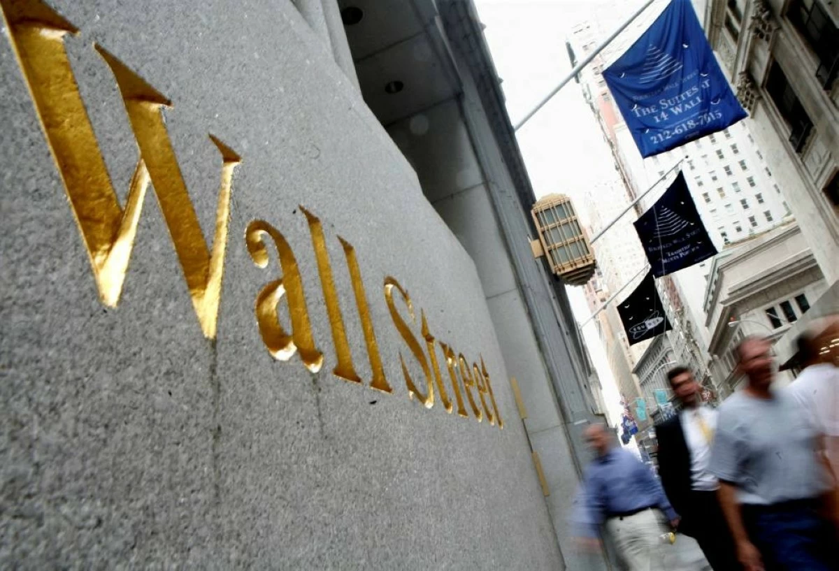 File picture: People walk along Wall Street near the New York Stock Exchange. On Friday, U.S. markets also declined. The S&P 500 dropped 1.2% from its record high set a day earlier. The Dow Jones Industrial Average fell 1.1%, while the Nasdaq Composite lost 1.5%. Picture credit: REUTERS