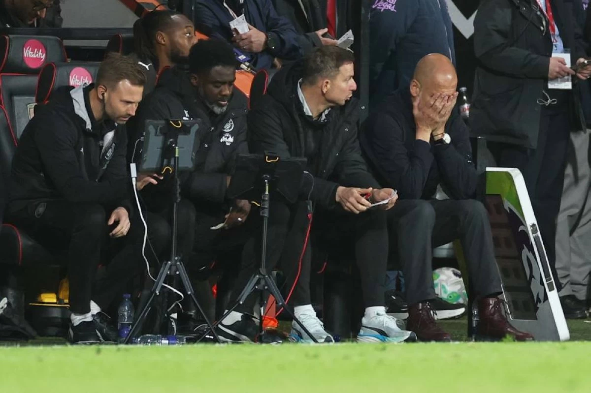 Manchester City's head coach Pep Guardiola, right, reacts during the English Premier League soccer match between AFC Bournemouth and Manchester City in Bournemouth, England, Tuesday, May 19, 2026. (AP Photo/Ian Walton)