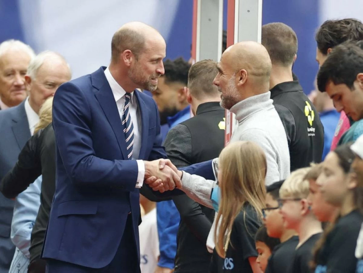 Britain's Prince William shakes hands with Manchester City manager Pep Guardiola before the FA Cup final match between Chelsea v Manchester City at Wembley Stadium, London, Britain on May 16, 2026. (Reuters)