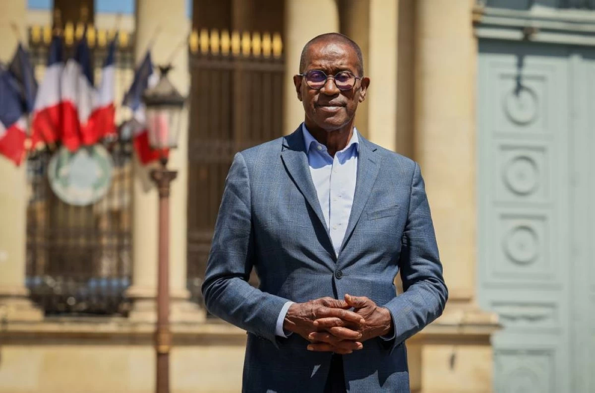 French lawmaker Max Mathiasin of the French Caribbean island Guadeloupe, poses at the entrance of the National Assembly in Paris, Wednesday, May 27, 2026, before lawmakers examine a bill to formally repeal the Code Noir, or Black Code, the 17th-century royal edict that governed slavery in French colonies and treated enslaved people as property. (AP Photo/Thomas Padilla)