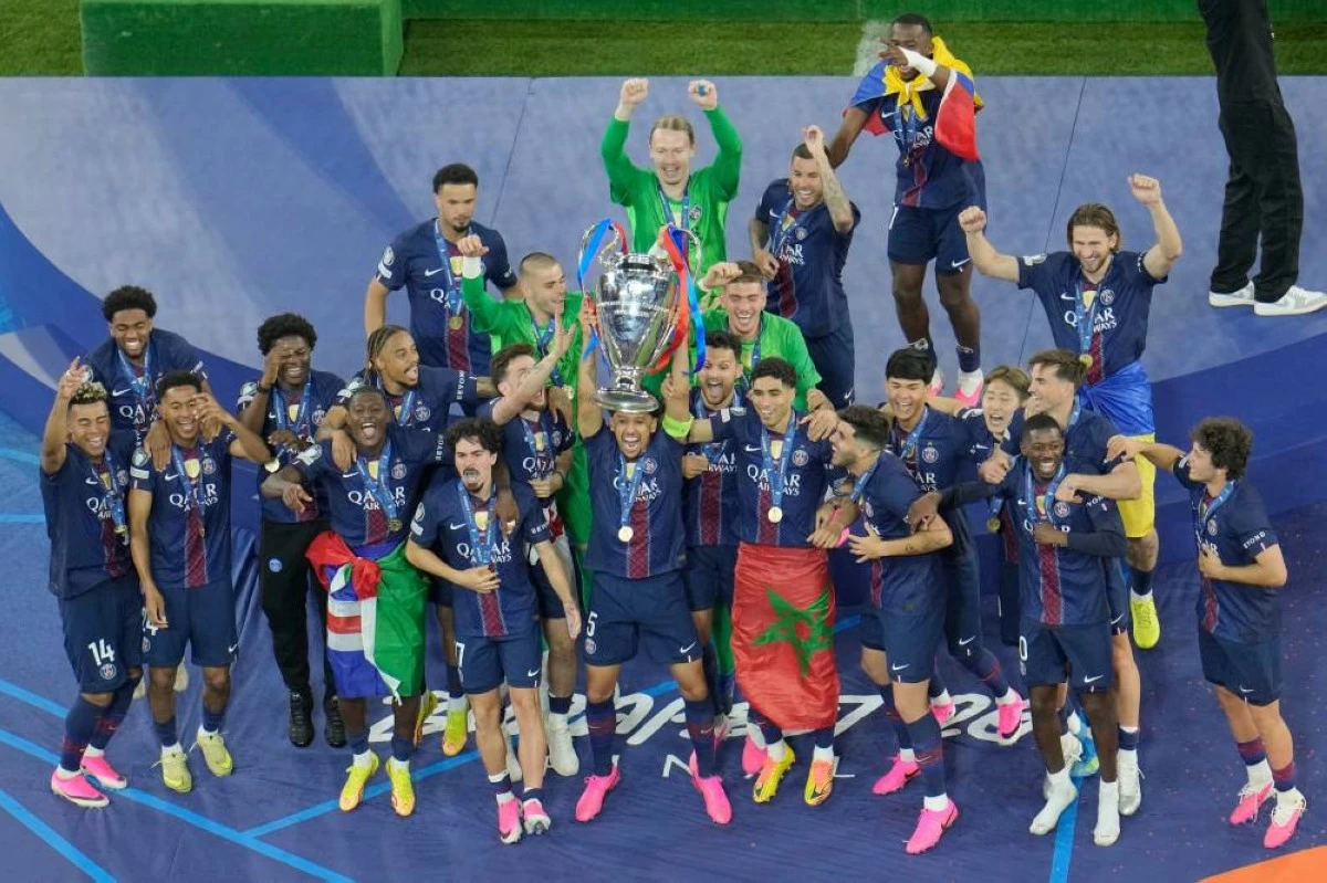 PSG players celebrate with the trophy after winning the Champions League final soccer match against Arsenal in Budapest, Hungary, Saturday, May 30, 2026. AP