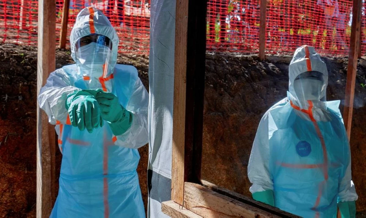 In this file photo, health workers get dressed in personal protective equipment (PPE) at the Evangelical Medical Center, in Bunia, Ituri province, Democratic Republic of Congo. Picture credit: Reuters