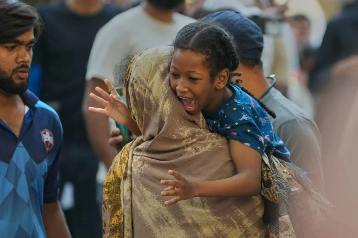 A girl reacts after being rescued from a hotel fire in New Delhi, India, Wednesday, June 3, 2026. (AP Photo/Manish Swarup)