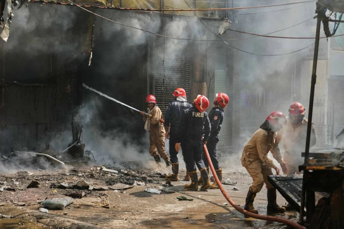 Firefighters douse a fire in a hotel in New Delhi, India, Wednesday, June 3, 2026. (AP Photo/Manish Swarup)