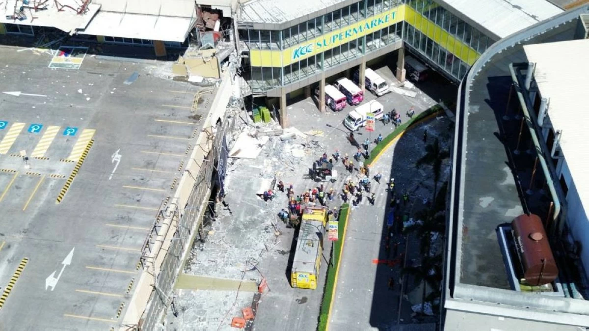 A drone view shows emergency personnel and people standing near damaged buildings after a magnitude 7.8 quake in General Santos, Mindanao Island, Philippines, June 8, 2026. GenSan DEV/Handout via REUTERS   
