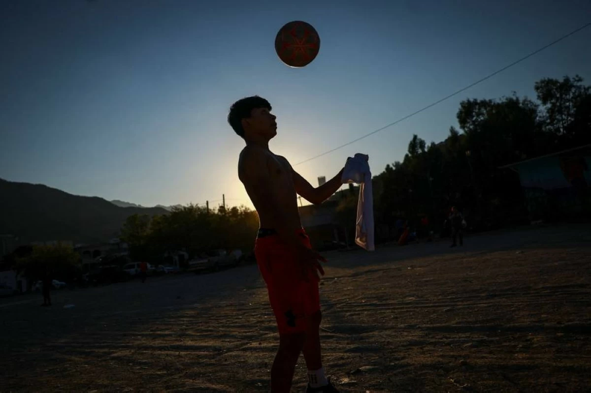 Humberto Guadalupe, 14, nicknamed "Messi," who dreams of becoming a professional soccer player, plays during a soccer match that begins with listening to the word of God, followed by snacks organized by evangelists and brothers Rene and Andres Cardona in Monterrey, Mexico, March 24, 2026. REUTERS/Raquel Cunha 