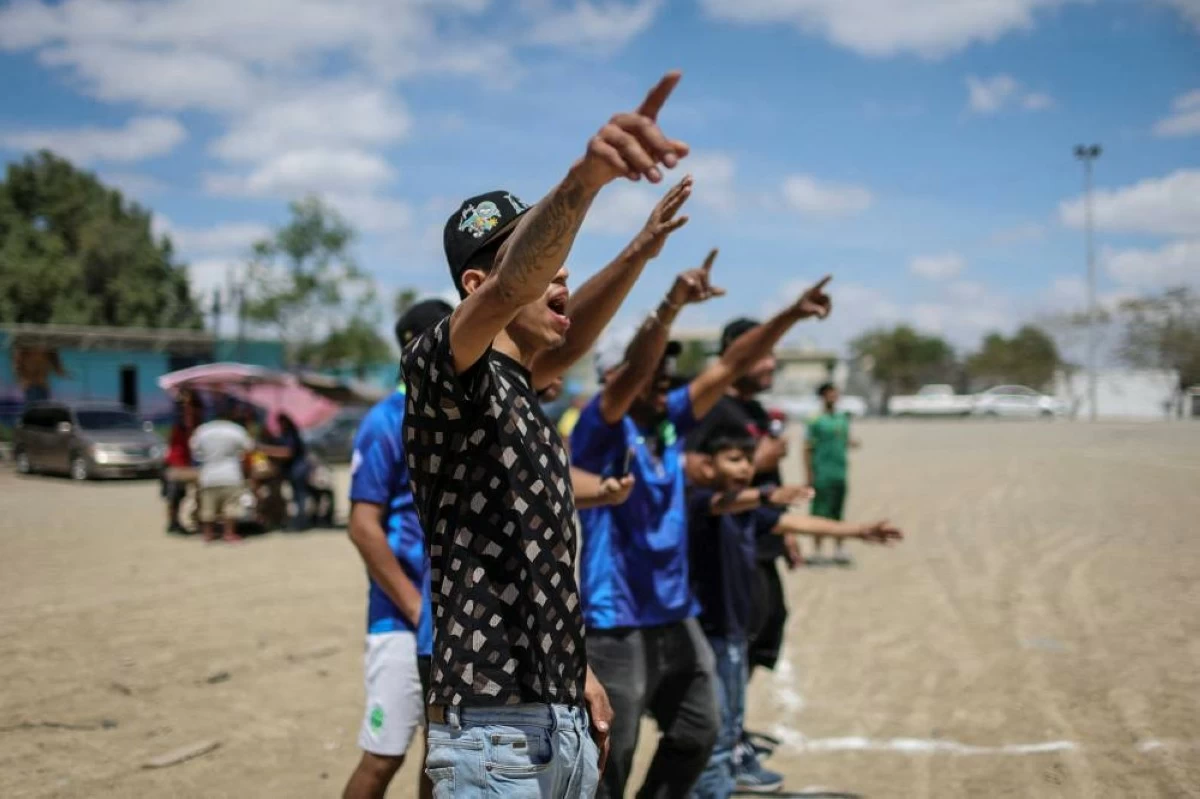 People cheer for the 'Pandilleros' team during the Cerro de la Campana llanero soccer championship semifinal against 'Bandoleros' at Los Pinos football pitch in Monterrey, Mexico, March 29, 2026. REUTERS/Raquel Cunha 