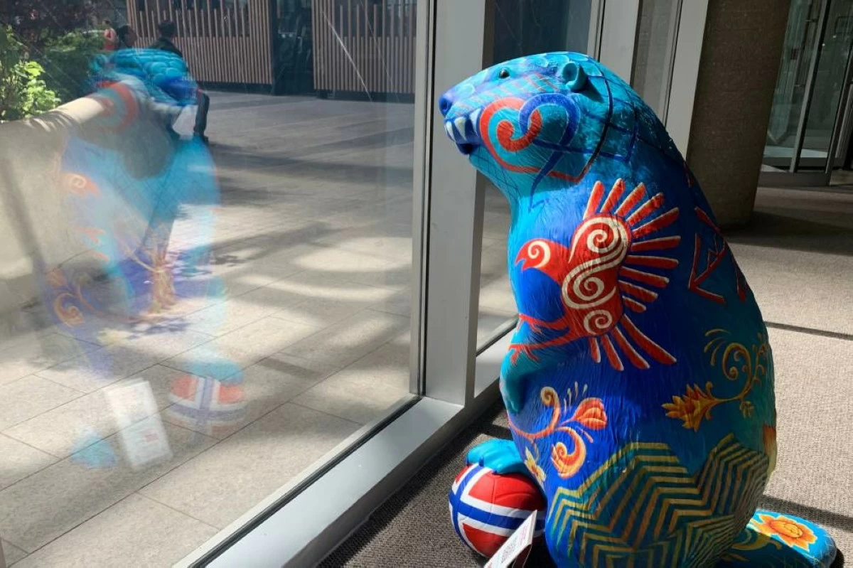 A beaver sculpture representing Norway stares out an office building lobby. Picture credit: AP