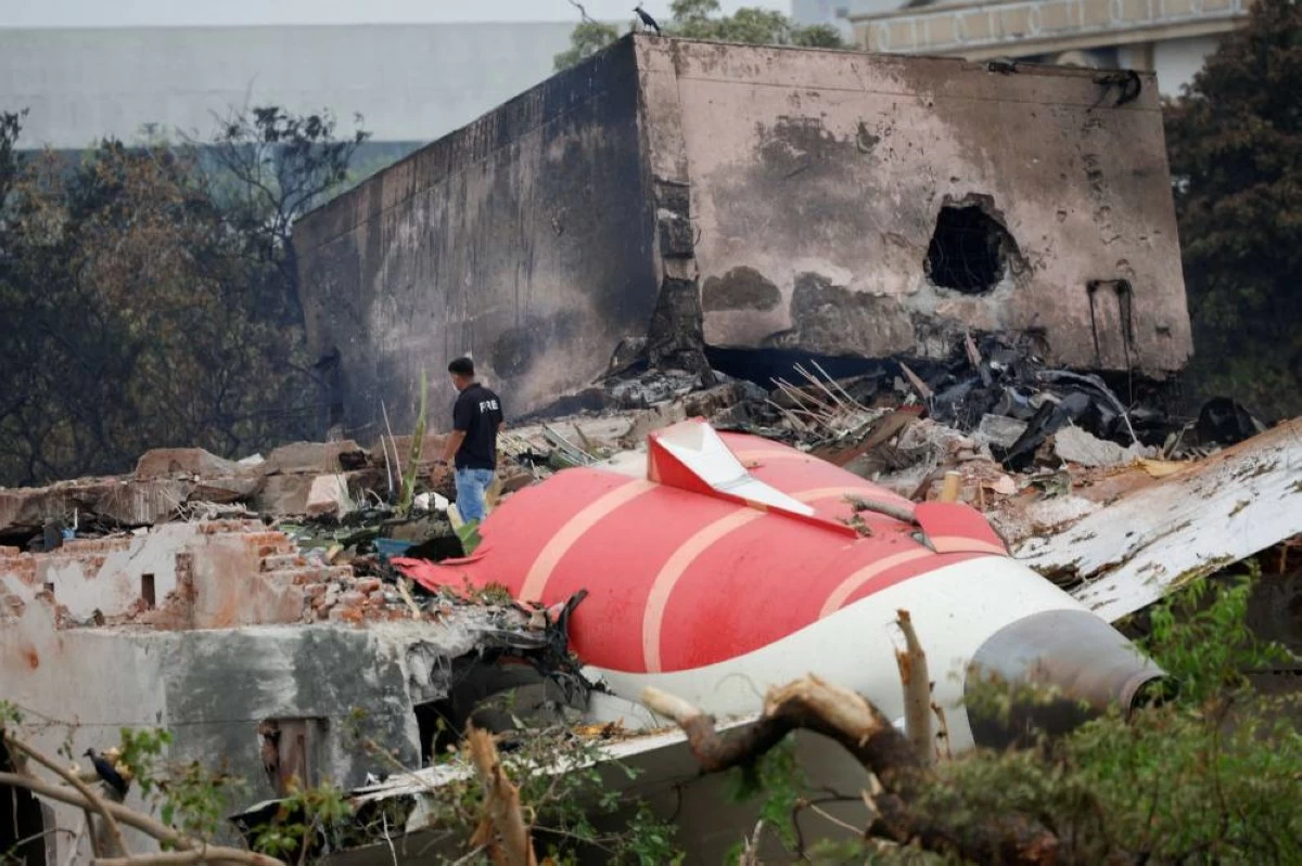 An official stands next to the crashed Air India Boeing 787-8 Dreamliner aircraft, in Ahmedabad, India, June 13, 2025. REUTERS/Adnan Abidi/File Photo