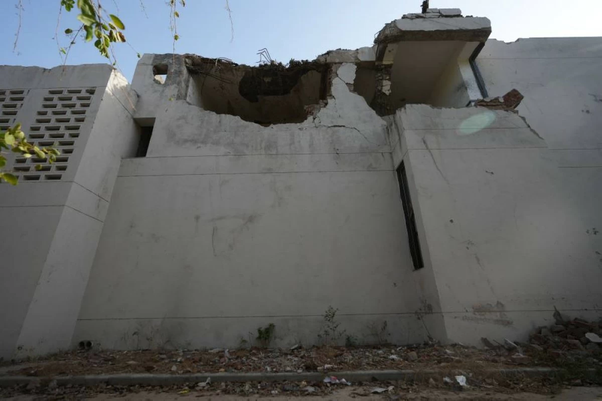 A damaged building, where the tail of the Air India place was stuck after deadly crash on the June 12, 2025, is seen in Ahmedabad, India, Wednesday, June 10, 2026. (AP Photo/Ajit Solanki)