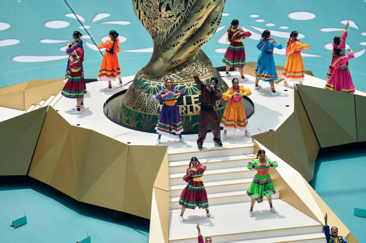 Performers on the base of the World Cup statue. Picture credit: AP