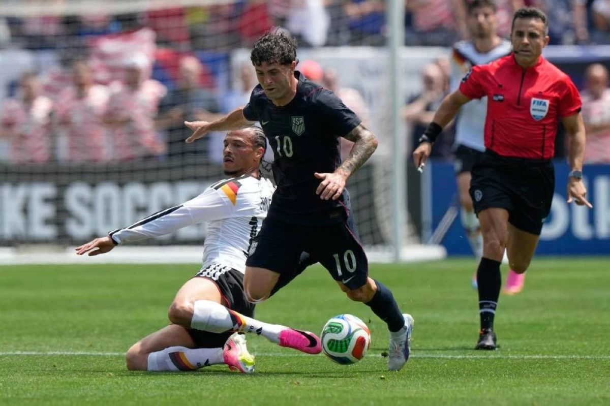 Pulisic, right, is tackled by Germany forward Leroy Sané during the first half of an international friendly soccer match in Chicago on June 6. Picture credit: AP