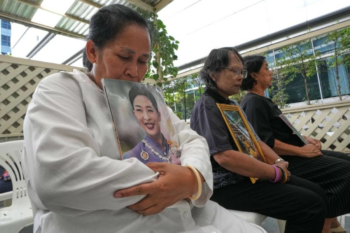 People hold pictures of Thailand's Princess Bajrakitiyabha Mahidol in Bangkok, Thailand, Friday, June 12, 2026. (AP Photo/Sakchai Lalit)
