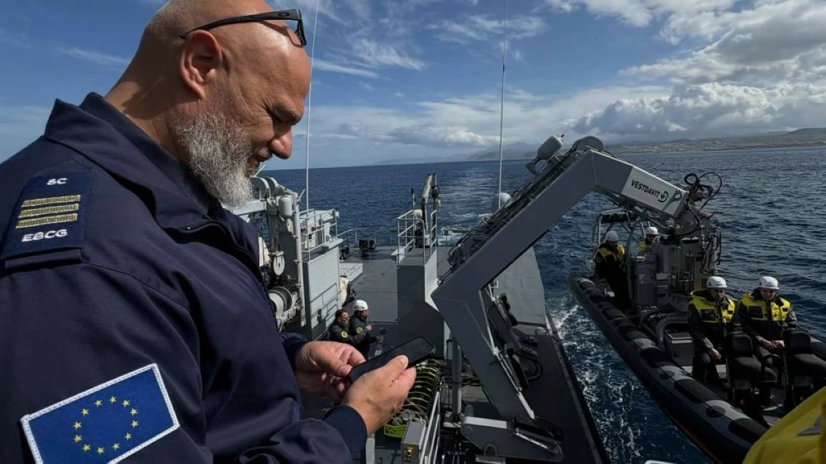 Frontex Contingent Commander Georgios Pyliaros takes pictures of Frontex officers from the Guardia di Finanza OPV Osum as they prepare in their speedboat to be lowered into the sea during a patrol in the Aegean Sea near Heraklion, Crete, Greece, Feb. 16, 2026. (AP)