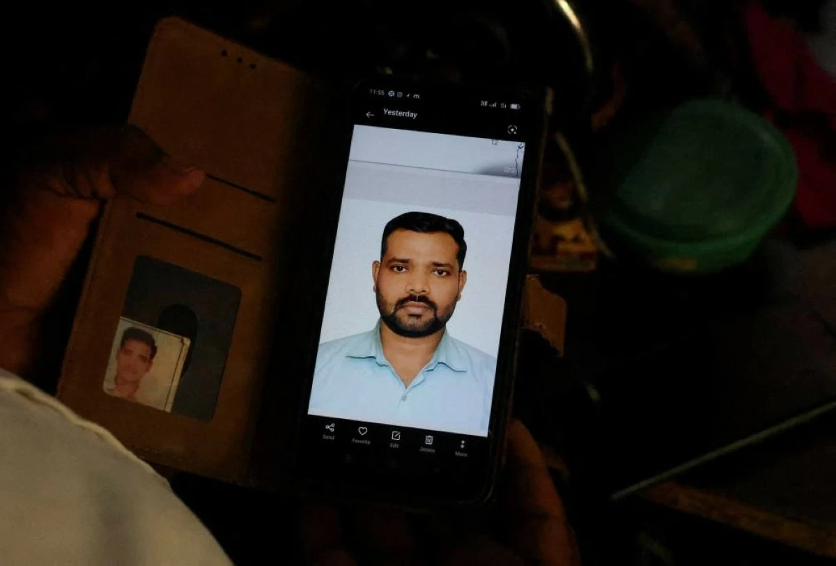 Sanjay Chaurasia, brother-in-law of Shivanand Chaurasia, an Indian seafarer aboard the Palau-flagged tanker MT Settebello, who was among three crew members killed in one of the U.S. attacks on Indian-crewed tankers this week amid a blockade of Iran-related shipping, shows a picture of Shivanand on his phone in Deoria, Uttar Pradesh, India, June 12, 2026. REUTERS/Priyanshu Singh