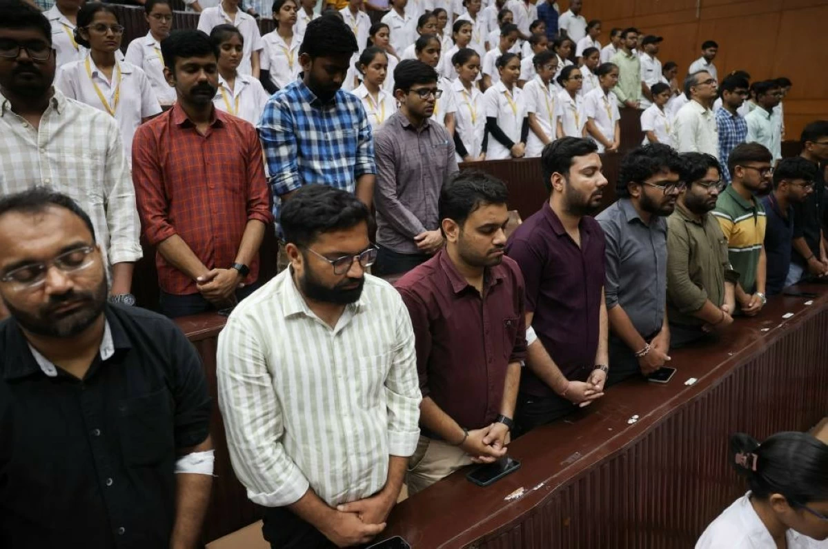 People observe a moment of silence as they attend the memorial ceremony during the first anniversary of Air India Boeing 787-8 Dreamliner crash on June 12, 2025, at B.J. Medical College and Civil hospital in Ahmedabad, India, June 12, 2026. REUTERS/Amit Dave