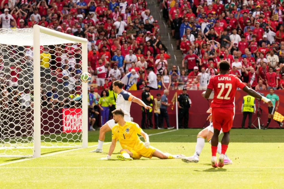 Canada's Richie Laryea (22) watches as his shot at goal is cleared away off the crossbar by Bosnia's Sead Kolasinac, rear, the second half of the World Cup Group B soccer match between Canada and Bosnia. Picture credit: AP