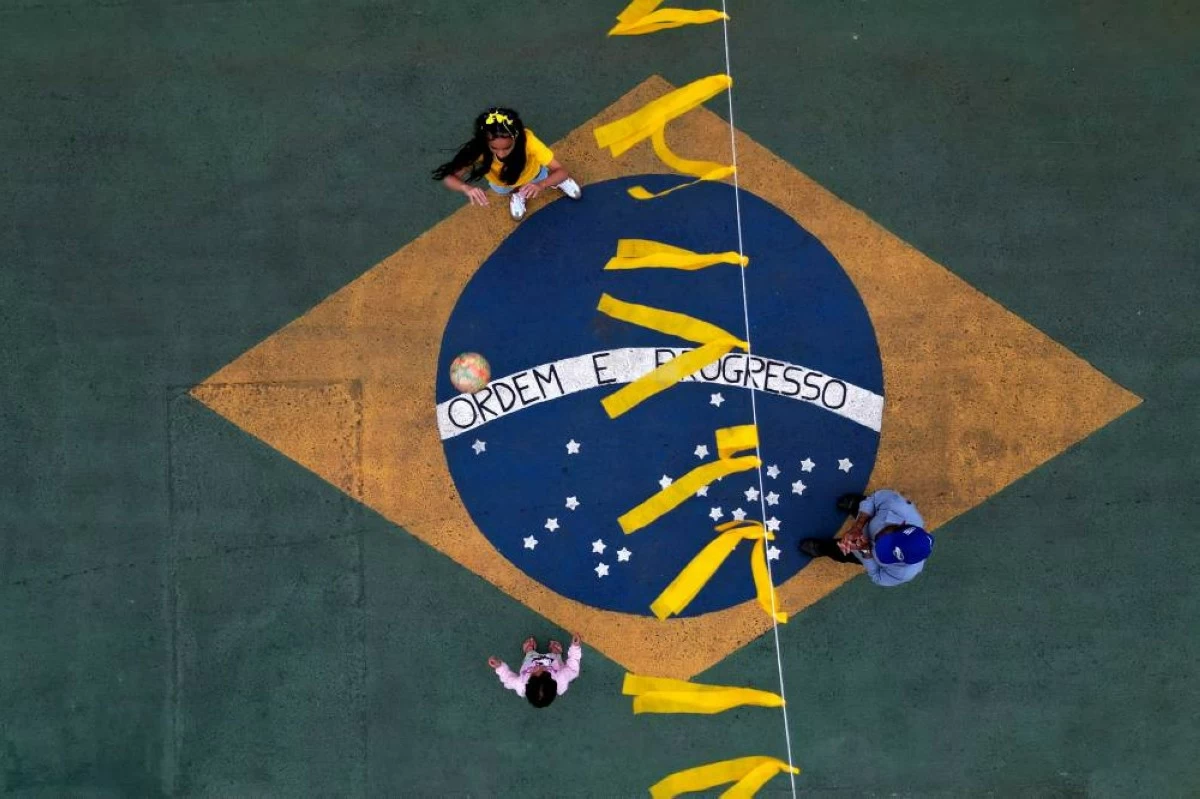 Children play on a street painted with a Brazilian flag in Brasilia, Brazil, Wednesday, June 10, 2026, ahead of the World Cup tournament. Picture credit: AP
