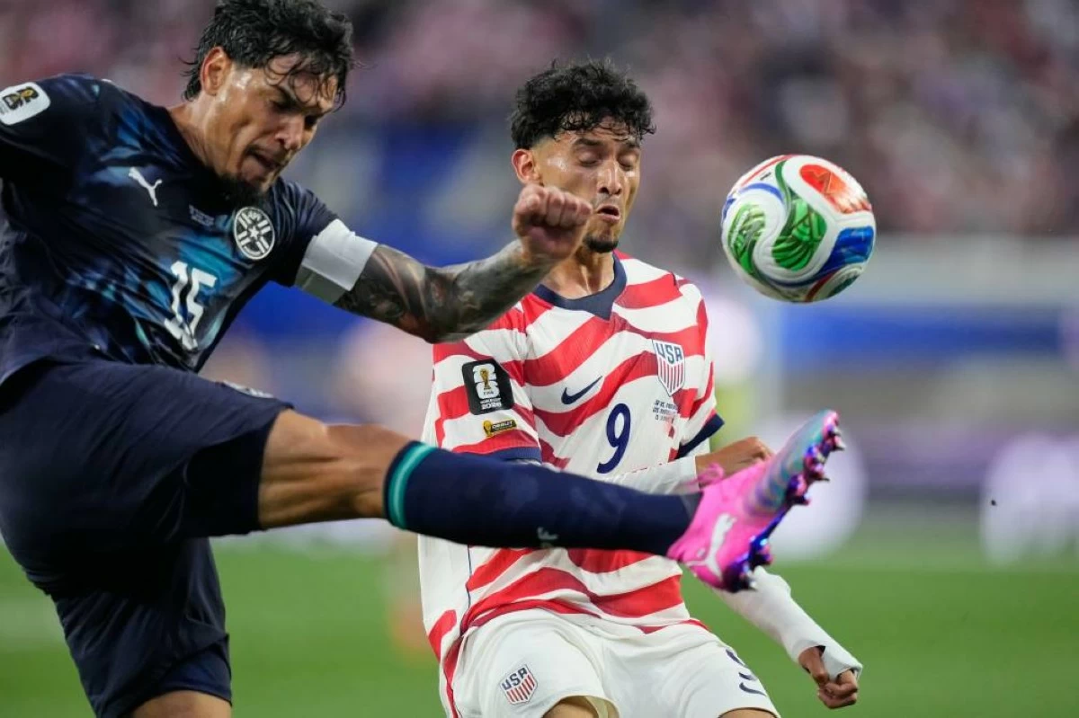 Paraguay's Gustavo Gomez, left, kicks the ball clear of United States' Ricardo Pepi during the World Cup Group D soccer match between the United States and Paraguay in Inglewood, Calif., near Los Angeles, Friday, June 12, 2026. (AP Photo/Mark J. Terrill)
