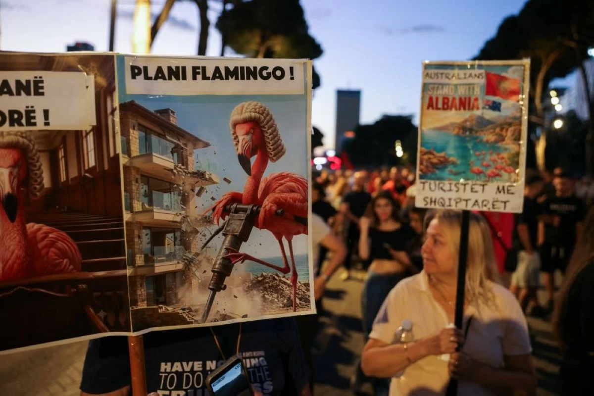 Protesters hold placards during a protest against a luxury resort, a plan by a company linked to Donald Trump's son-in-law, Jared Kushner, on an environmentally sensitive part of the Adriatic coast, in Tirana, Albania, June 12, 2026. REUTERS/Valdrin Xhemaj