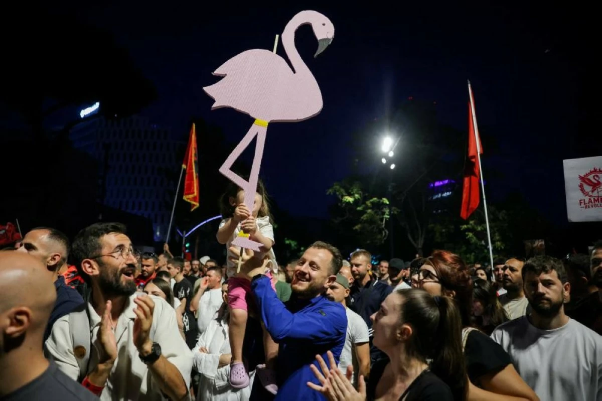 A protester holds a caricature of a flamingo as the symbol of the "Flamingo Revolution" during a protest against a luxury resort, a plan by a company linked to Donald Trump's son-in-law, Jared Kushner, on an environmentally sensitive part of the Adriatic coast, in Tirana, Albania, June 12, 2026. REUTERS/Valdrin Xhemaj