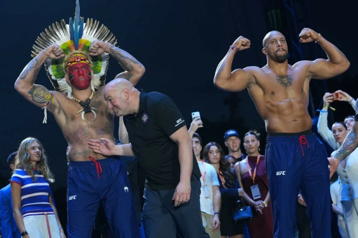 UFC commentator Joe Rogan, center, with Alex Pereira, left, and Ciryl Gane, right, during the ceremonial UFC Freedom 250 weigh-ins on the Ellipse, Saturday, June 13, 2026, in Washington, ahead of Sunday's fight on the South Lawn of the White House. AP