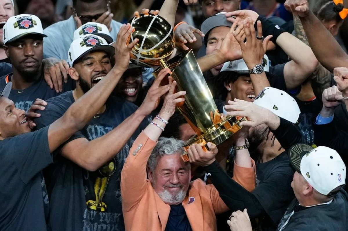 New York Knicks owner James L. Dolan celebrates with his players after defeating the San Antonio Spurs in Game 5 of the NBA Finals basketball series. AP