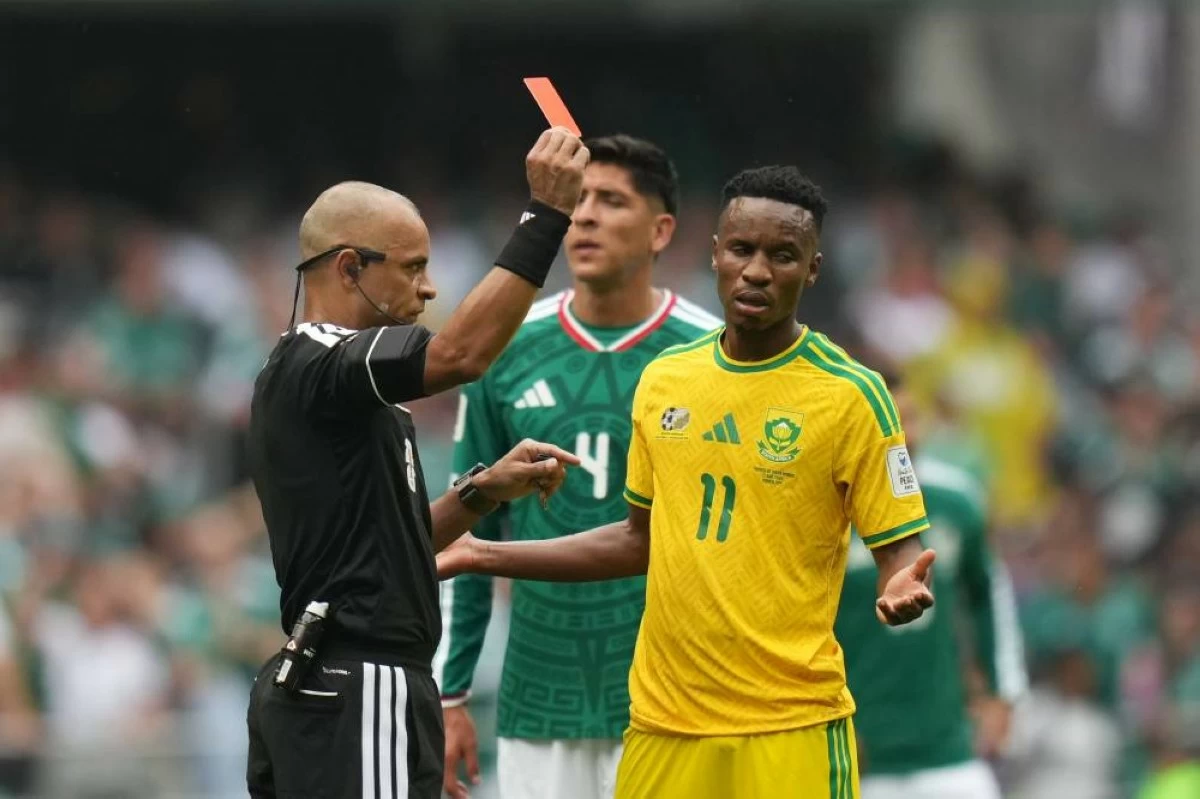 Referee Wilton Sampaio, of Brazil, show the red card to South Africa's Themba Zwane during the World Cup Group A soccer match between Mexico and South Africa in Mexico City. Picture credit: AP