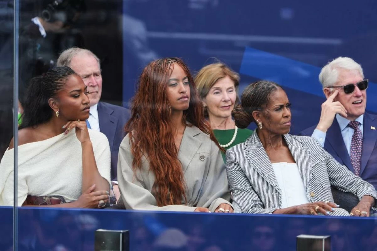 From left, Sasha, Malia and Michelle Obama listen as former President Barack Obama speaks during the dedication ceremony for the Obama Presidential Center, Thursday, June 18, 2026, in Chicago. (AP Photo/Jeff Roberson)
