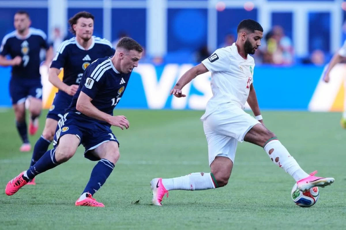 Morocco's Ismael Saibari, right, controls the ball followed by Scotland's Lewis Ferguson during the World Cup Group C soccer match between Scotland and Morocco. Picture credit: AP