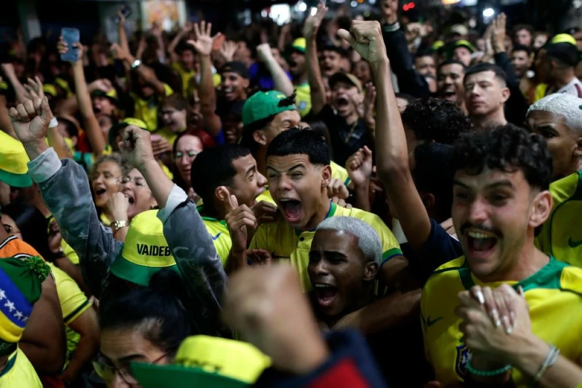 Football fans celebrate Brazil's second goal against Haiti during a World Cup watch party at the Rocinha favela in Rio de Janeiro. Picture credit: AP