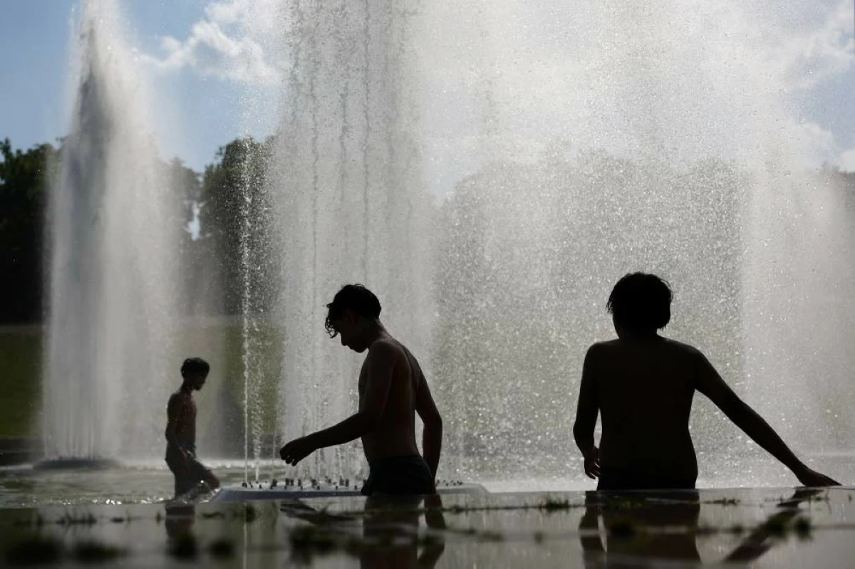 Children cool off in the Trocadero Fountain next to the Eiffel Tower in Paris. Reuters