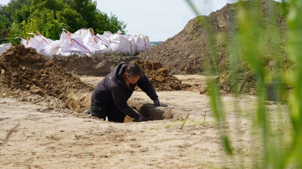 An archaeologists excavates a Viking Age pit house in Aarhus, Denmark, on June 22, 2026. (AP Photo/James Brooks)