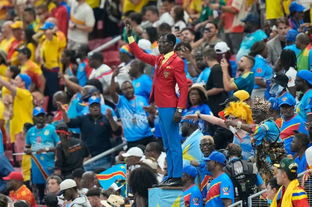 Michel Nkuka Mboladinga poses as a statue Patrice Lumumba ahead of the World Cup Group K soccer match between Colombia and Congo. He missed Congo's opener against Portugal because of Ebola quarantine requirements. (AP Photo/Fernando Llano)
