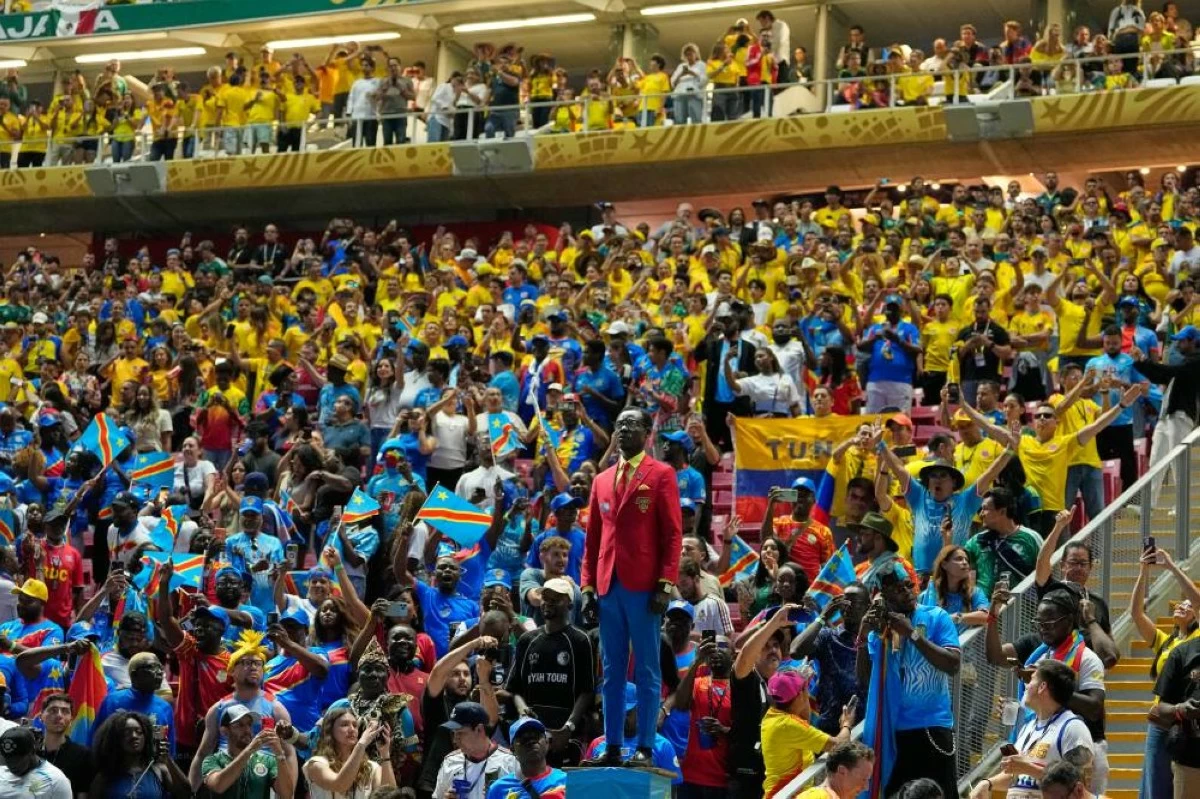 Another view of Michel Nkuka Mboladinga as a statue of Congo's independence hero Patrice Lumumba, at the World Cup Group K soccer match between Colombia and Congo. Lulumba became independent Congo’s first prime minister but he was assassinated within a year, during a struggle with Belgian-backed movement. (AP Photo/Natacha Pisarenko)