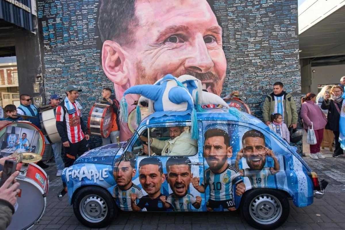 People gather to sing happy birthday to Lionel Messi at a street mural of him in Buenos Aires, Argentina. Picture credit: AP
