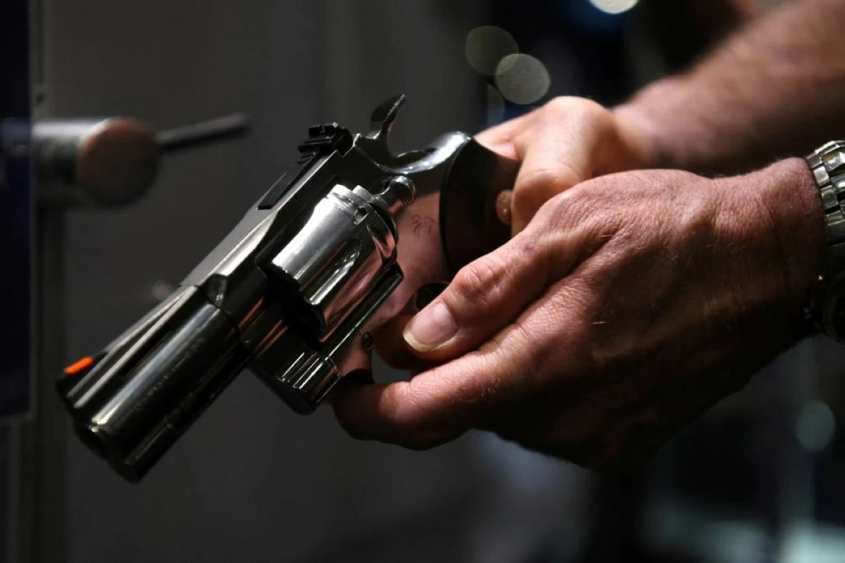 An attendee tries out a gun on display at the National Rifle Association (NRA) annual convention in Houston, Texas, U.S. May 28, 2022. REUTERS