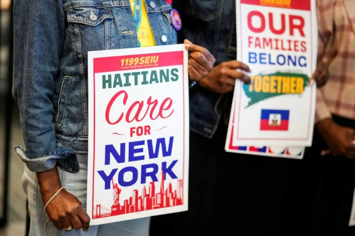 People hold placards during a rally with immigration advocates, on the day of the U.S. Supreme Court ruling allowing the Trump administration to strip Temporary Protected Status (TPS) protections from hundreds of thousands of Haitian and Syrian migrants, in New York City, U.S., June 25, 2026. REUTERS