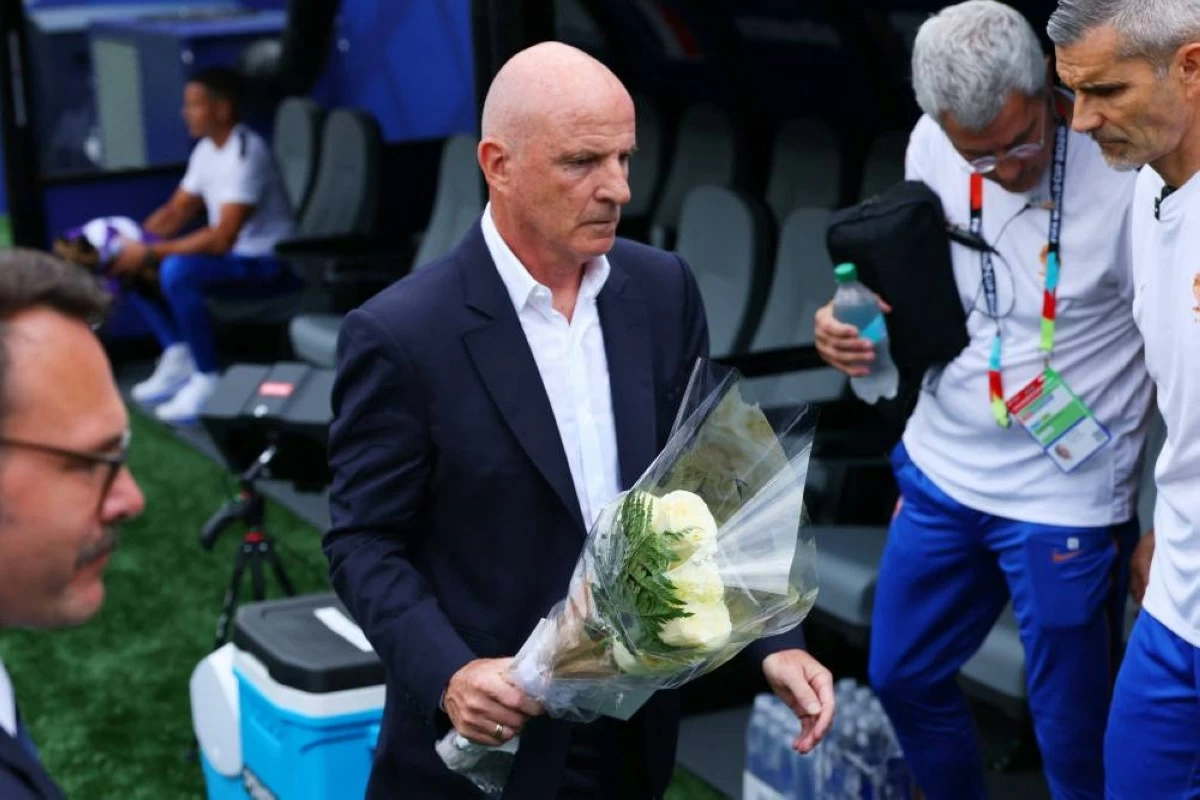 Interim France coach Guy Stephan with a bouquet of flowers in tribute following the passing of Didier Deschamps' mother, Ginette Deschamps. Picture credit: Reuters