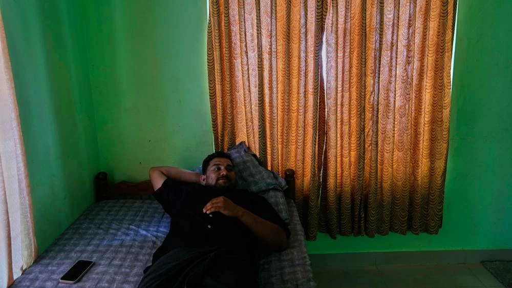 Safeer Mohammed Koorimannil rests in his brother's house after work, in Sulthan Bathery in the southern state of Kerala, India, Thursday, March 12, 2026, where he returned after paying to be freed from a scam compound in Myanmar. (AP)