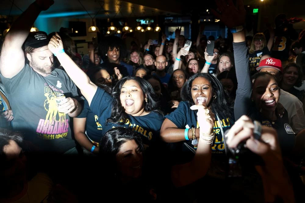 Supporters cheer after the second round of results came in with Democratic congressional candidate Melat Kiros leading during an election night watch party at The Broadway, Tuesday, June 30, 2026, in Denver. (AP Photo/Rebecca Slezak)