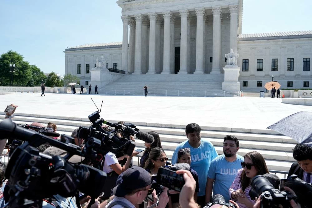 Members of the media interview supporters of the U.S. Supreme Court's birthright citizenship ruling, on the day the court is set to issue the final rulings of its nine-month term, in Washington, D.C., U.S., June 30, 2026. REUTERS