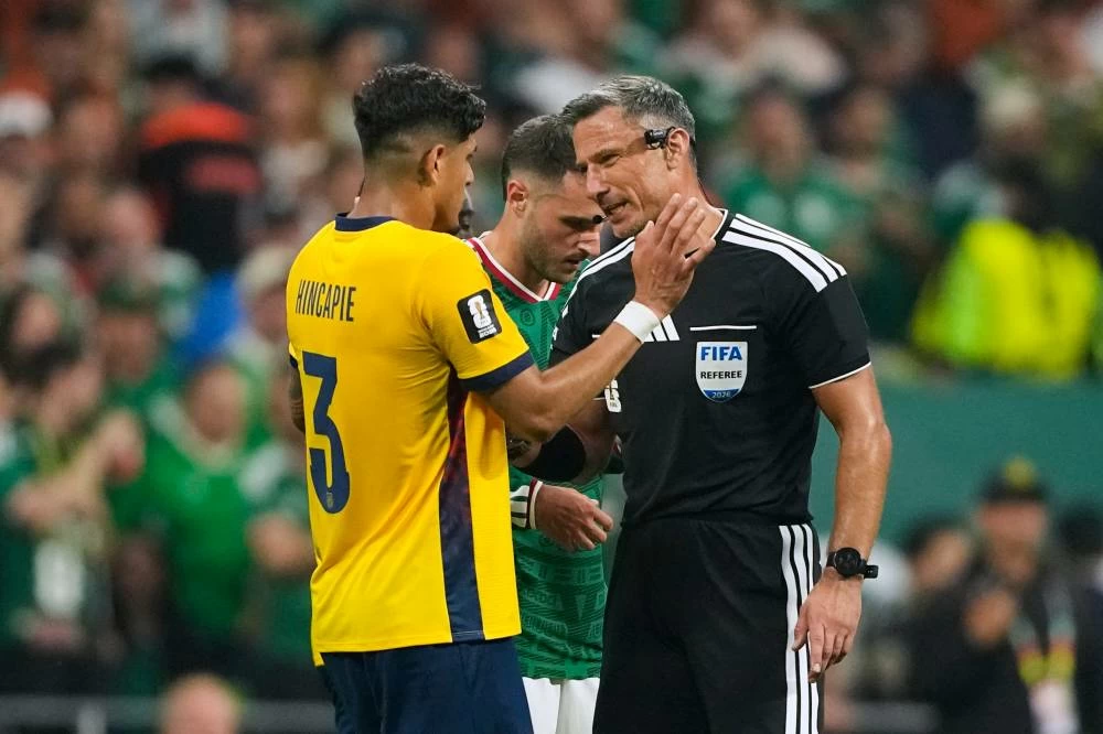 Referee Slavko Vincic of Slovenia speaks to Ecuador's Piero Hincapie (3) before sending him from the field during the World Cup round of 32 soccer match between Mexico and Ecuador in Mexico City, Tuesday, June 30, 2026. (AP)
