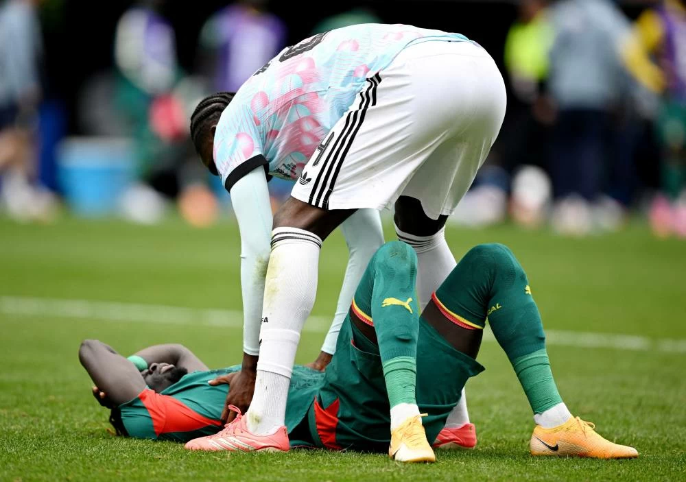 Senegal's Pathe Ciss with Belgium's Amadou Onana after the match. Picture credit: Reuters