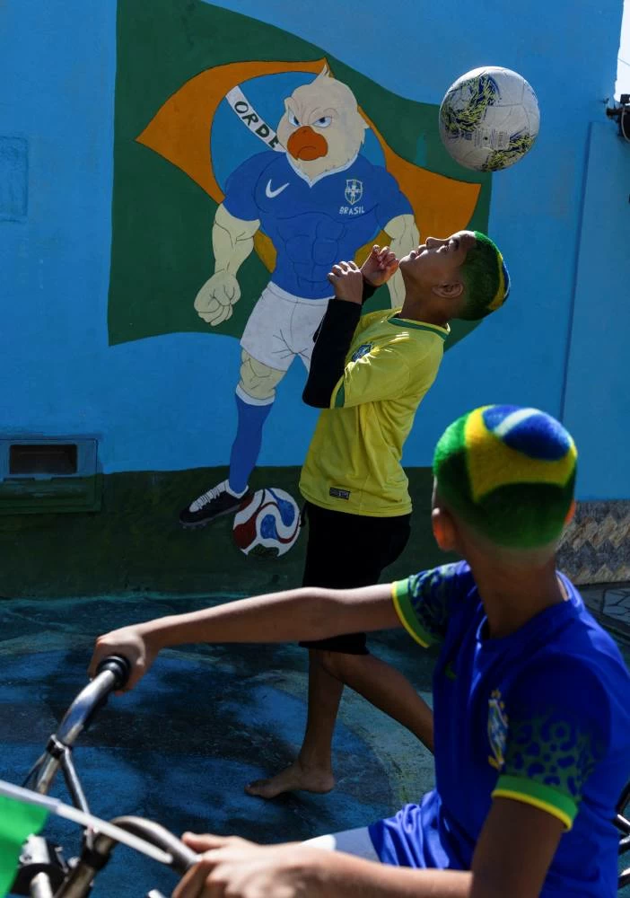 Guilherme Henrique da Silva, 11, with Brazilian flag colour hairstyle designed by barber Washington Rodrigo for the FIFA World Cup 2026, plays soccer in Resende, Brazil. Picture credit: Reuters