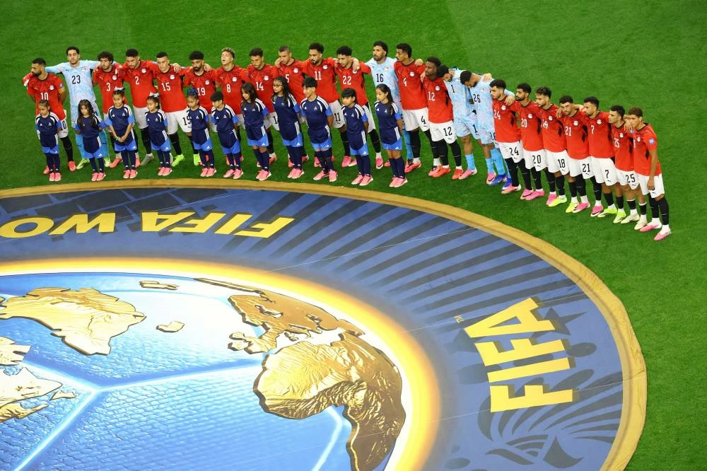 Egypt players line up during the national anthems before the match against Australia. REUTERS