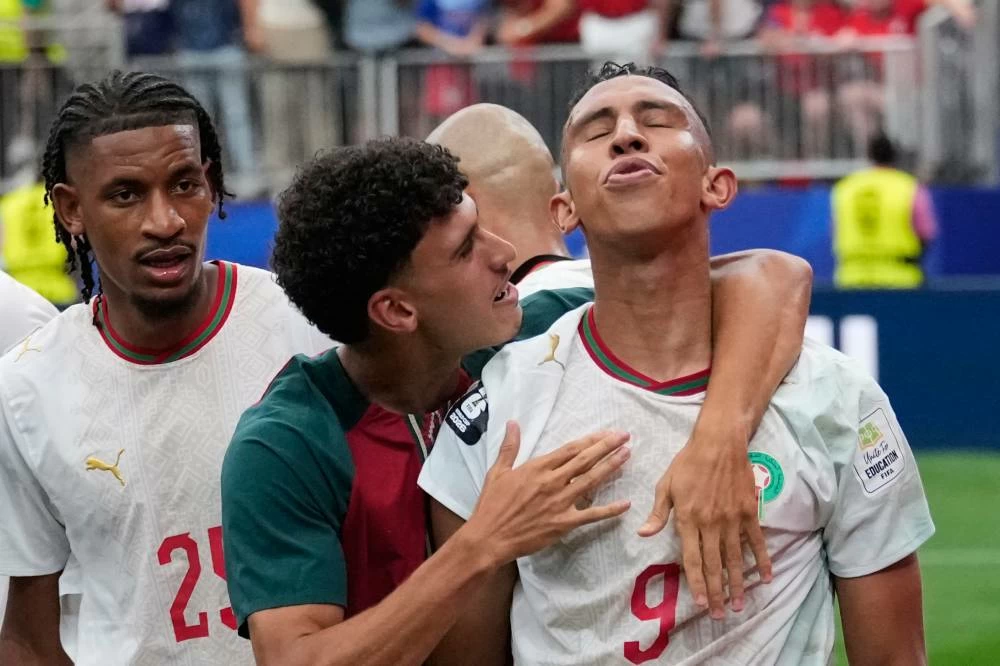 Morocco's Soufiane Rahimi, right, is congratulated by teammates after scoring his side's 3rd goal against Canada during the World Cup round of 16 soccer match in Houston, Saturday, July 4, 2026. (AP Photo/David J. Phillip)