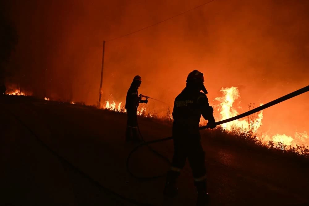 Wildfires rage in Portugal as Greece warns citizens over poisonous smoke